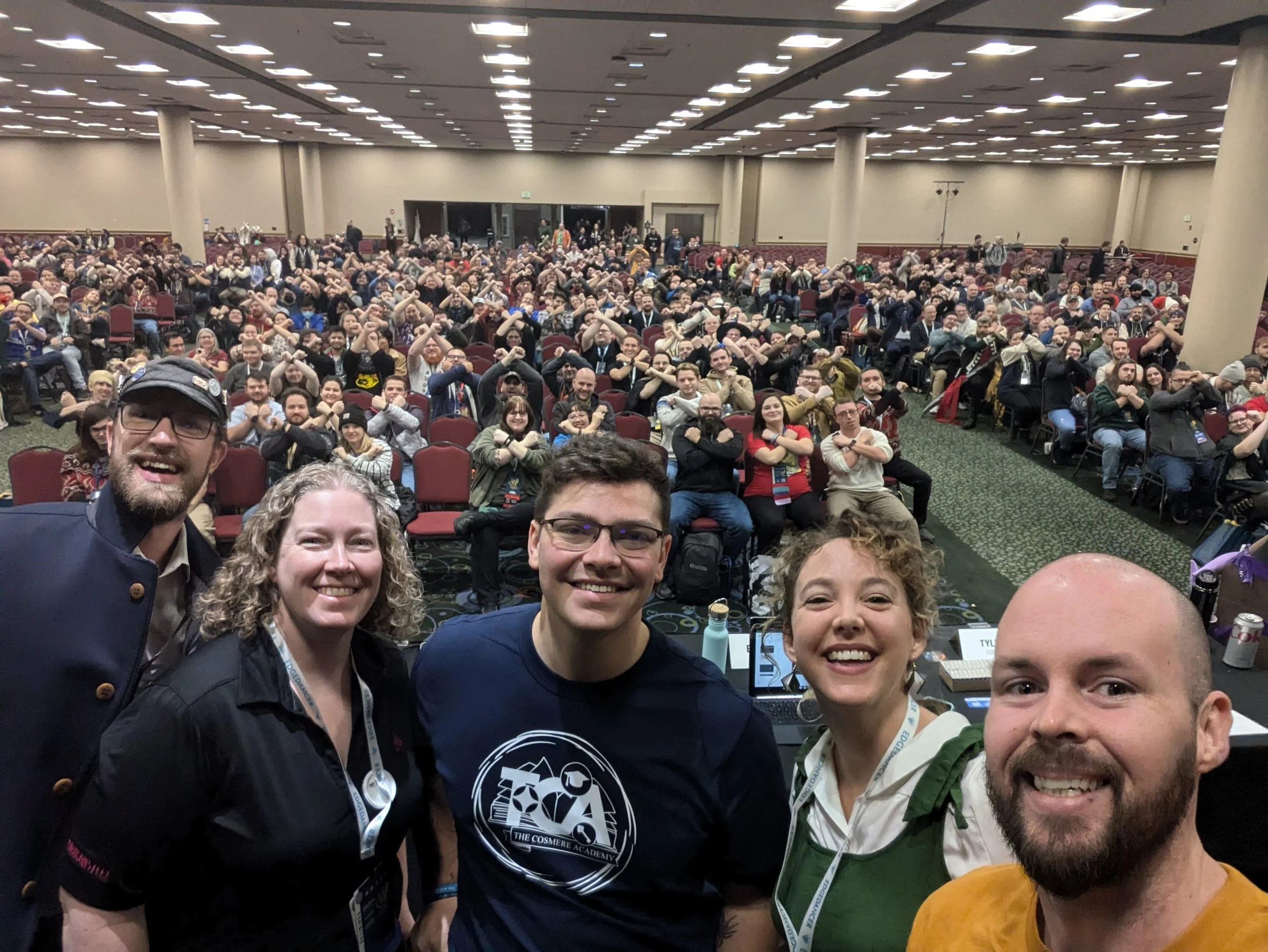 Tyler and Brooke on a panel stage at Dragonsteel Nexus 2024, hundreds of fans behind them